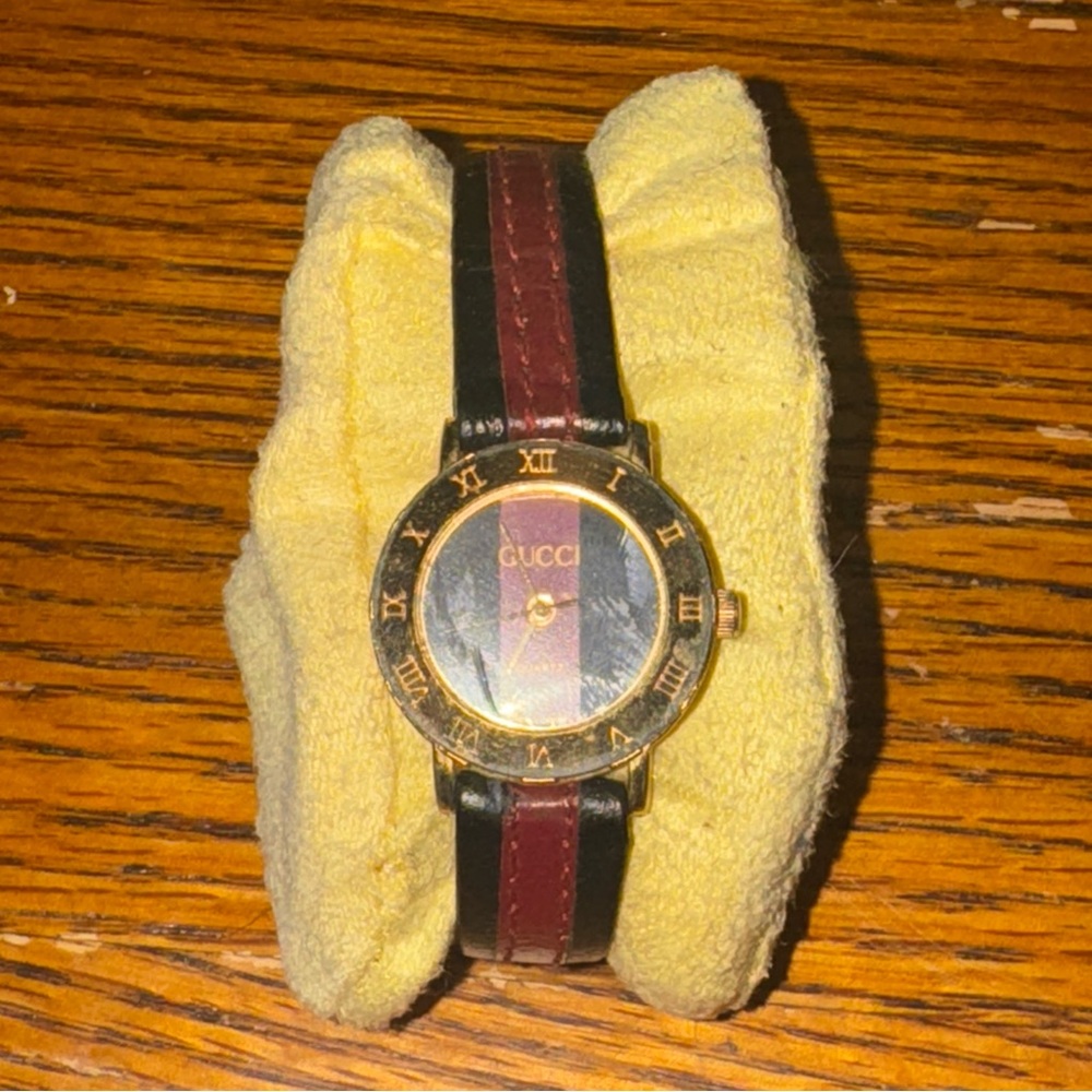 Gucci Black and Red Timepiece with Gold Details
